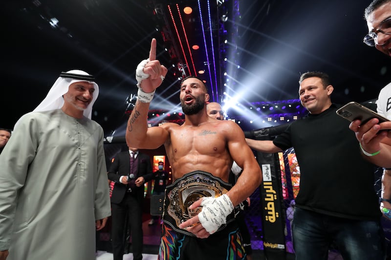 Ali Taleb celebrates his victory against Vincius de Oliveira in the bantamweight title fight at UAE Warriors 30.