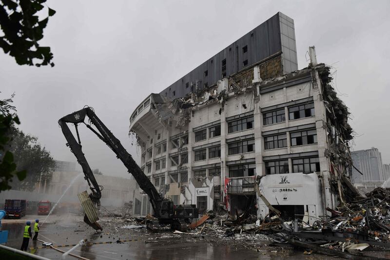 Demolition expert knock down the Workers' Stadium in Beijing. The stadium, originally built in 1959 and which later hosted football competition at the 2008 Beijing Olympic Games, is to be rebuilt. AFP