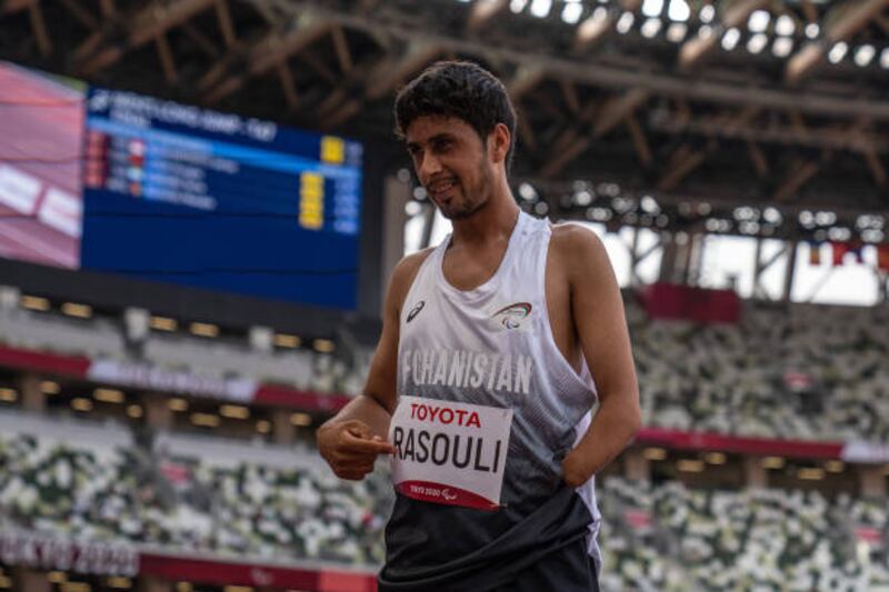 Hossain Rasouli points to his name tag after competing in the men's long jump T47 final. Getty