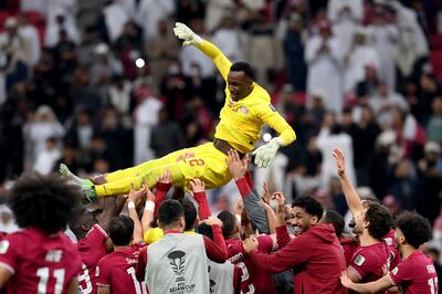 Qatar players celebrate by throwing goalkeeper Meshaal Barsham in the air following his shoot-out heroics. Getty Images