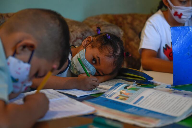 Children attend class in an improvised classroom in a house in Petare neighbourhood, Venezuela's largest slum, in Caracas. AFP