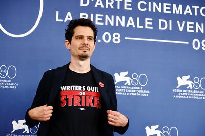 Jury president Damien Chazelle with a T-shirt supporting striking Hollywood writers. Reuters