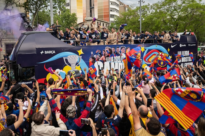 Barcelona supporters welcome the players during an open-top bus parade through the city. Getty Images