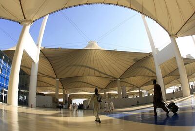 People walk outside the King Abdulaziz Airport upon their arrival to the Red Sea port city of Jeddah. AFP