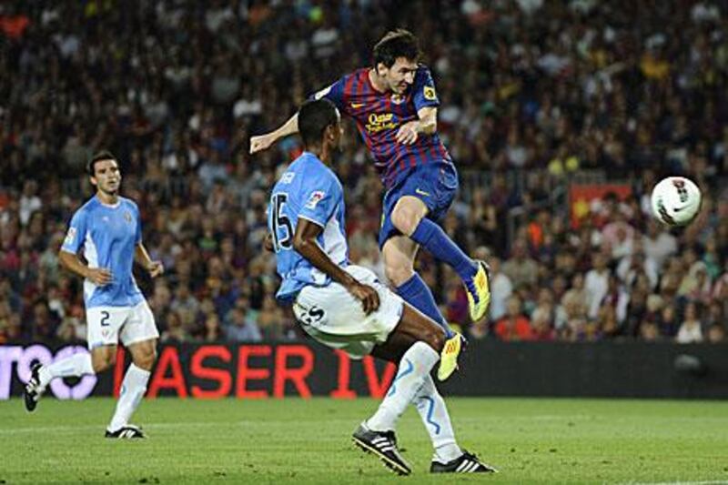 Lionel Messi heads towards goal in Barcelona's rampant 8-0 victory over Osasuna.