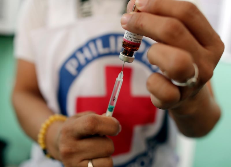 epa07373902 A Philippine Red Cross (PRC) health worker prepares a measles vaccine during a nationwide response program to immunization people at a slum area in Manila, Philippines, 16 February 2019. According to reports, an intensive vaccination program has been launched in Metro Manila and other affected areas to fight the measles outbreak. More than 70 people, mostly children under four-years of age, have been confirmed dead from the measles outbreak and over 4,300 people have fallen ill.  EPA/FRANCIS R. MALASIG