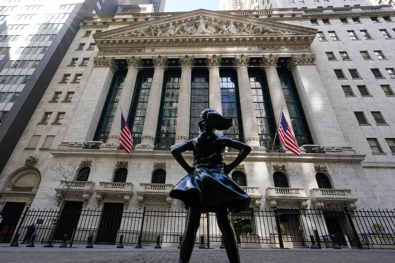 FILE - In this Tuesday, March 23, 2021 file photo, the Fearless Girl statue stands in front of the New York Stock Exchange in New York's Financial District. Stocks are off to a sluggish start on Wall Street as the market loses more momentum following its rise to records last week. The S&P 500 was wavering between small gains and losses in the early going Tuesday, April 13 while gains for several Big Tech stocks pushed the Nasdaq up 0.8%. (AP Photo/Mary Altaffer, File)