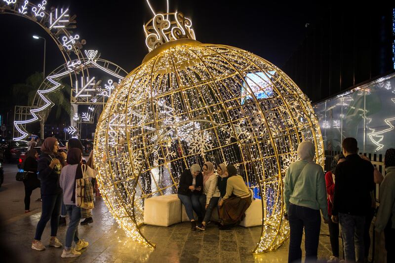 People gather to look at Christmas lights and decorations in fifth settlement district in Cairo, Egypt. EPA