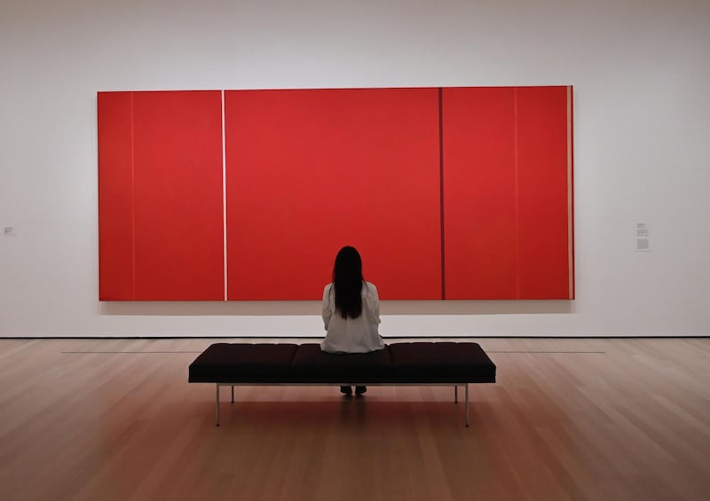 A member of the media looks at Barnett Newman's "Vir Heroicus Sublimis" during a press preview for the expanded and re-imagined Museum of Modern Art (Moma). AFP