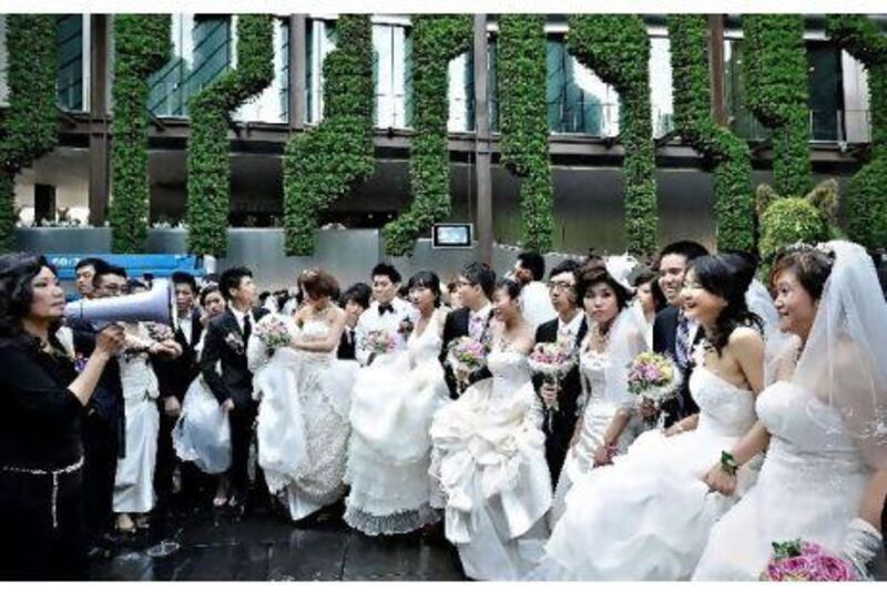 Couples gather for a mass wedding at the at the French pavilion on the site of the World Expo 2010 in Shanghai in May.