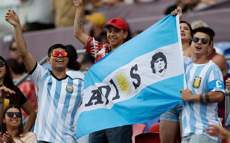 Argentina fans hold a flag in memory of the late football star Diego Maradona. PA