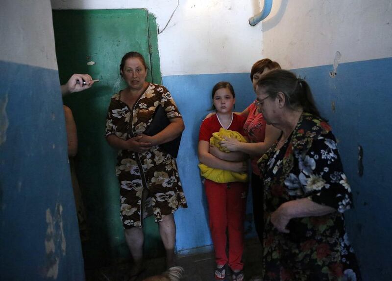 A family takes shelter in a building near Donetsk international airport during heavy fighting. Yannis Behrakis / Reuters