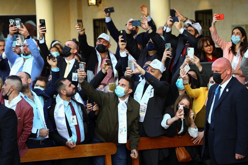 People take pictures with their mobiles upon the arrival of Pope Francis. Reuters