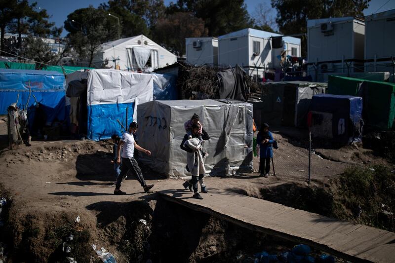 Migrants make their way at a makeshift camp surrounding the Moria migrant camp on the island of Lesbos, Greece, February 18, 2020. Picture taken February 18, 2020. REUTERS/Alkis Konstantinidis