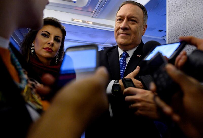 US Secretary of State Mike Pompeo (R) speaks to reporters onboard his plane as he flies from Ethiopia to Saudi Arabia.  AFP
