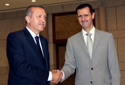 Syrian President Bashar Assad, right, shakes hands with Turkish Prime Minister Recep Tayyip Erdogan, left, in Damascus in 2010. AP
