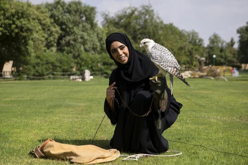 Jawaher Al Shamsi with one of the falcons that she trains at Al Ain Zoo. The Emirati has been working with birds at the city’s zoo for the past four years. Christopher Pike / The National