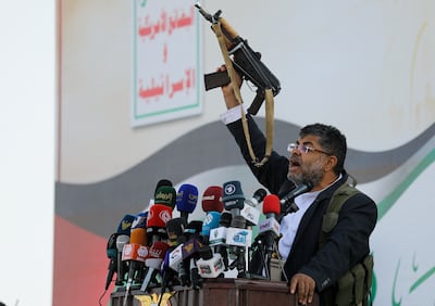 Mohammed Ali Al Houthi, a member of the Houthi supreme political council, brandishes a gun while speaking to supporters at a rally in Sanaa after the US and UK strikes. Reuters