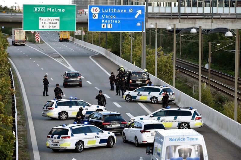 epa07054426 Police vehicles block the street leading to the Oeresund Bridge near Copenhagen, Denmark, 28 September 2018. Media reports state that Danish police closed bridges and ferry connection on the eastern island of Zealand because of a 'major police operation', according to information of the Copenhagen Police on Twitter. No further details on the size and background of the police operation were immediately availabe.  EPA/NILS MEILVANG DENMARK OUT
