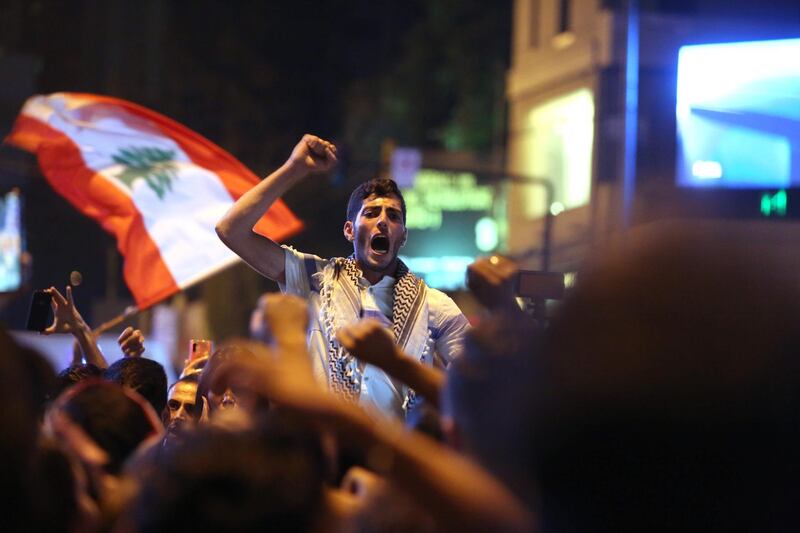 Lebanese anti-government protesters react to the speech of Lebanon's president Michel Aoun in Beirut. AFP