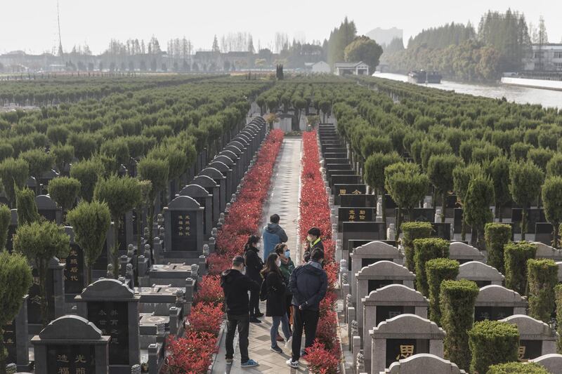 Visitors wearing protective masks gather in a public cemetery during the Qingming Festival in Shanghai, China. Bloomberg