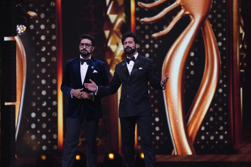 Hosts Abhishek Bachchan and Vicky Kaushal on stage