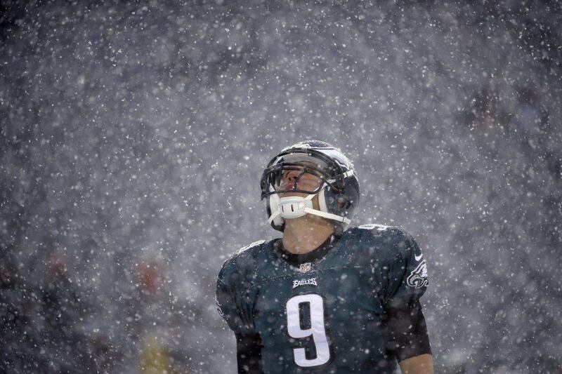 Philadelphia quarterback Nick Foles stares up into the snowfall. Matt Rourke / AP