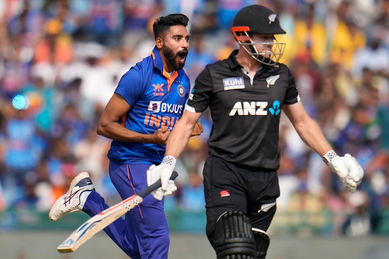 India's Mohammed Siraj, left, celebrates the dismissal of New Zealand's Henry Nicholls, right, during the second ODI in Raipur. AP