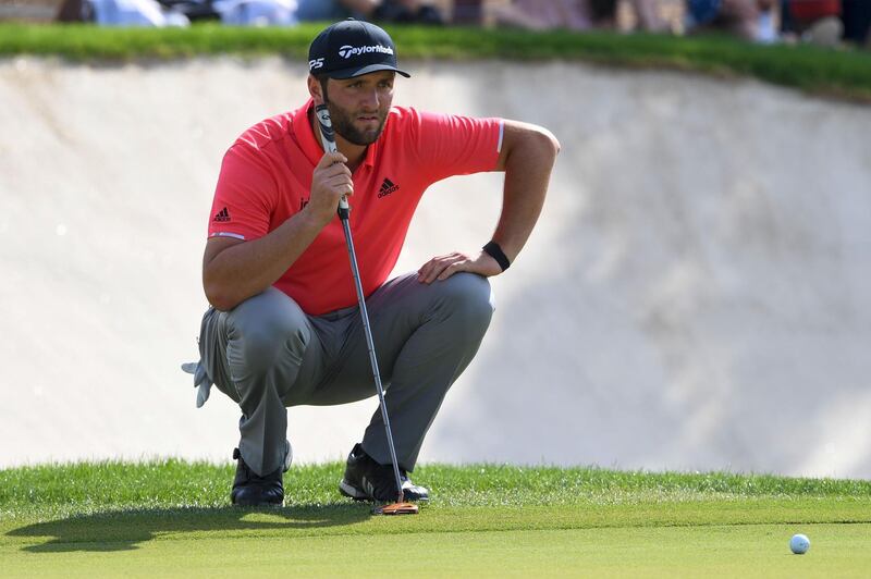 Jon Rahm lines-up a putt. AFP