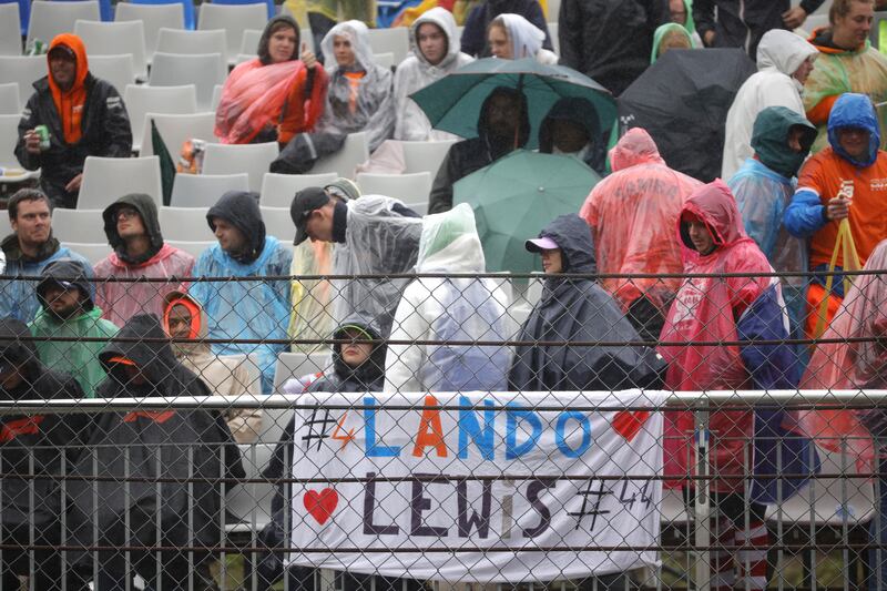 Spectators wait in the rain at Spa-Francorchamps. AP