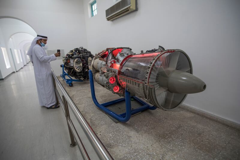 A visitor taking photo of an aircraft engine at the UAE's first flying school, which has been converted into Al Mahatta Museum in Sharjah.