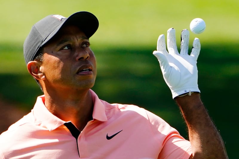 Tiger Woods catches a ball while practicing on the driving range at Augusta National. AP