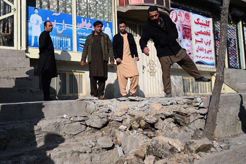Residents gather at a site after several rockets land at Khair Khana, north west of Kabul. A series of loud explosions shook central Kabul on November 21, including several rockets that landed near the heavily fortified Green Zone where many embassies and international firms are based, officials said.  AFP