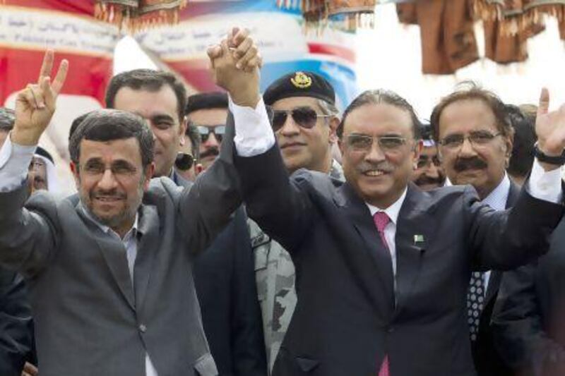 Iranian president Mahmoud Ahmadinejad, left, celebrates the inauguration of the Pakistan-Iran gas pipeline project with his Pakistani counterpart Asif Ali Zardari in Chahbahar near the Pakistani border in Iran.