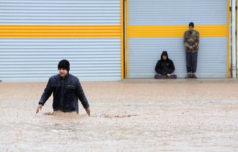 An Iranian man crosses a flooded street in the city of Khorramabad, Lorestan Province, western Iran.  EPA