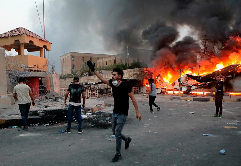 Protesters try to storm the governor's building in Basra. AP