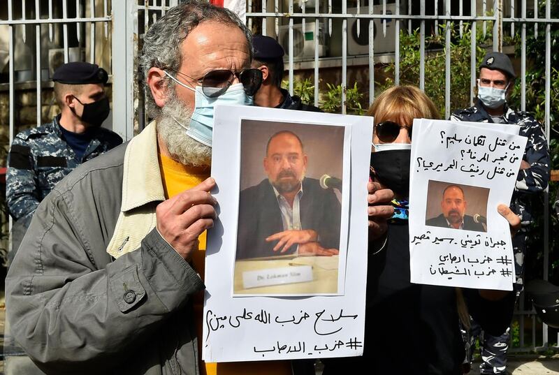 Protesters hold pictures of slain prominent Lebanese activist and intellectual Lokman Slim,  during a rally in front of the Justice Palace in the capital Beirut. AFP