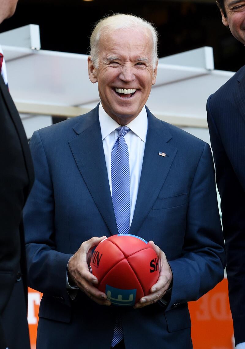 MELBOURNE, AUSTRALIA - JULY 17:  US Vice-President Joe Biden holds an AFL football as he speaks to the AFL CEO Gillon McLachlan and Mike Fitzpatrick before the round 17 AFL match between the Carlton Blues and the West Coast Eagles at the Melbourne Cricket Ground on July 17, 2016 in Melbourne, Australia. Biden is visiting Australia on a four day trip which includes a visit to Melbourne at the Victorian Comprehensive Cancer Centre to promote US-Australia cancer research and will host a round-table discussion with business leaders in Sydney. (Photo by Tracey Nearmy - Pool/Getty Images)