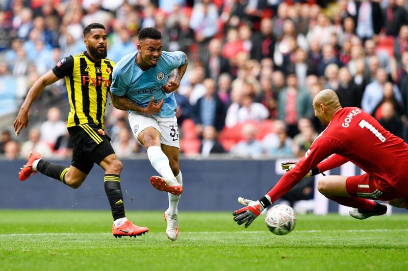 Manchester City striker Gabriel Jesus slots the ball past Watford goalkeeper Heurelho Gomes for City's fourth. EPA