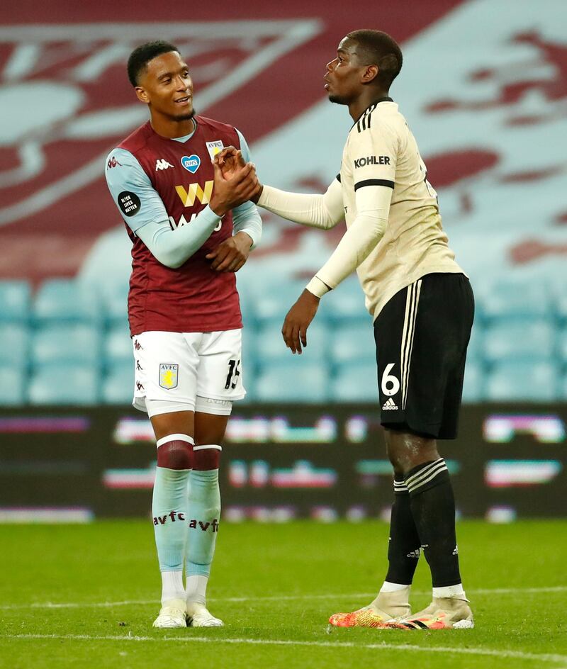 Manchester United's Paul Pogba, right, and Aston Villa's Ezri Konsa shake hands after the match at Villa Park on Thursday. AP