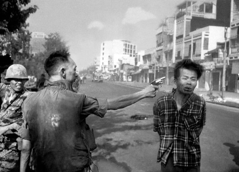 FILE - In this Feb. 1, 1968, file photo, South Vietnamese Gen. Nguyen Ngoc Loan, chief of the National Police, fires his pistol into the head of suspected Viet Cong officer Nguyen Van Lem (also known as Bay Lop) on a Saigon street, early in the Tet Offensive. "Vietnam: The Real War," a collection of 58 photographs taken by the AP opens to the public Friday, June 12, 2015, in Hanoi, (AP Photo/Eddie Adams, File)