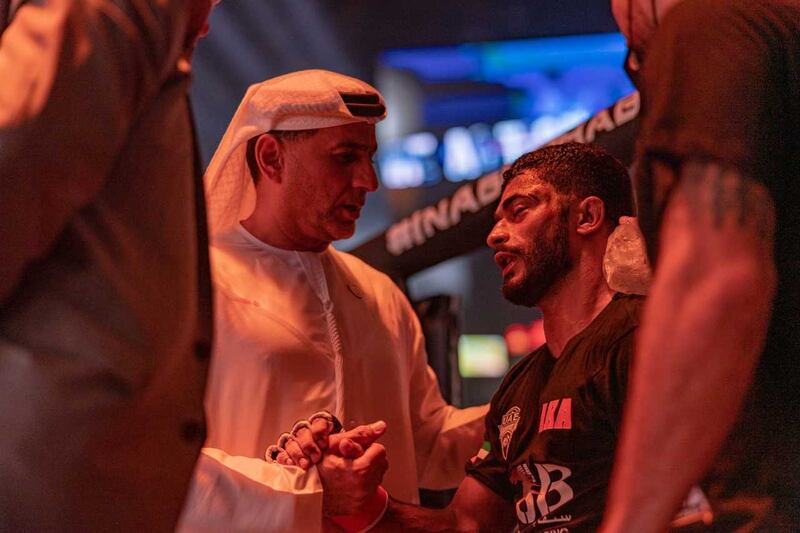 Emirati Hadi Omar Al Hussaini is comforted by Palms Sports chairman Abdulmunam Al Hashemi after a draw against Mohammad Qwai Abzakh. 