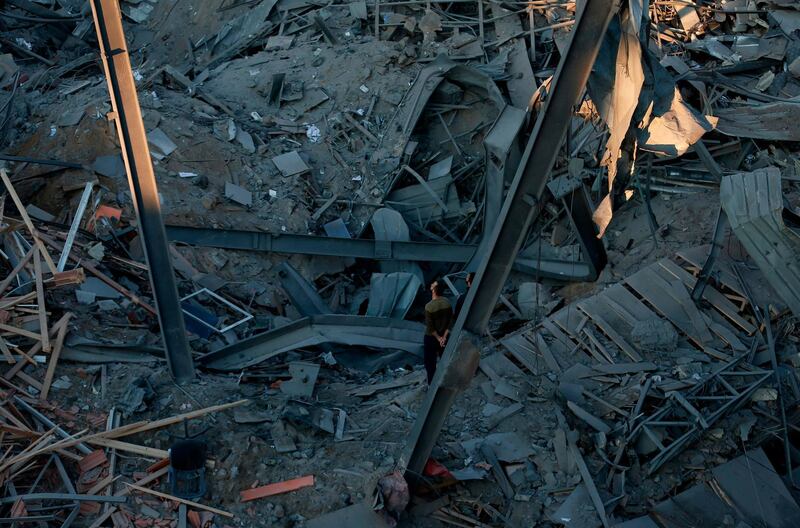 Palestinian men check the damage. AFP Photo