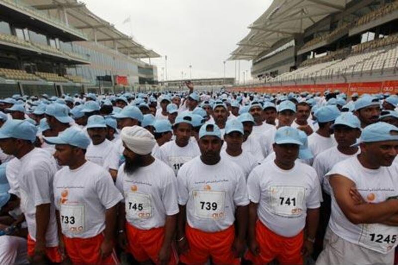 Workers at the start of the 4 kilometre run in celebration of Labor Day and organised by the Ministry of Labor at the Yas Marina track in Abu Dhabi.