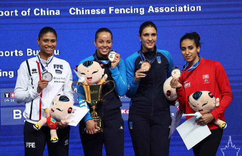 (L-R) Silver medalist Ysaora Thibus of France, gold medalist Alice Volpi of Italy, bronze medalist Arianna Errigo of Italy and Ines Boubakri of Tunisia pose for a photo during the award ceremony following the women's individual final of the foil competition at the 2018 World Fencing Championships in Wuxi in China's eastern Jiangsu province on July 23, 2018. (Photo by - / AFP) / China OUT