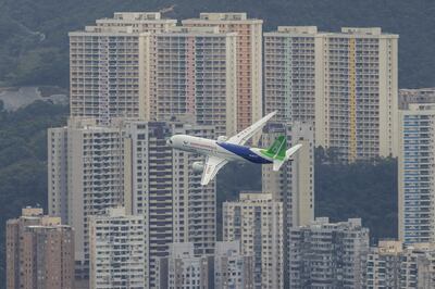 China's first domestically manufactured passenger aircraft Comac C919 flies over Victoria Harbour during its inaugural voyage outside the mainland, in Hong Kong, China in December 2023. Reuters