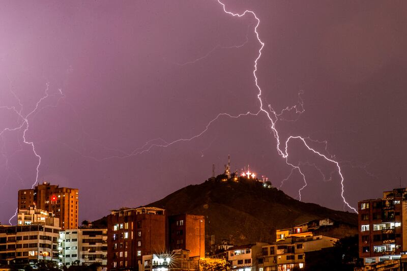 Lightning strikes over the "Cerro de las Tres Cruces" west of Cali, Colombia, during a thunderstorm.  Luis Robayo / AFP Photo