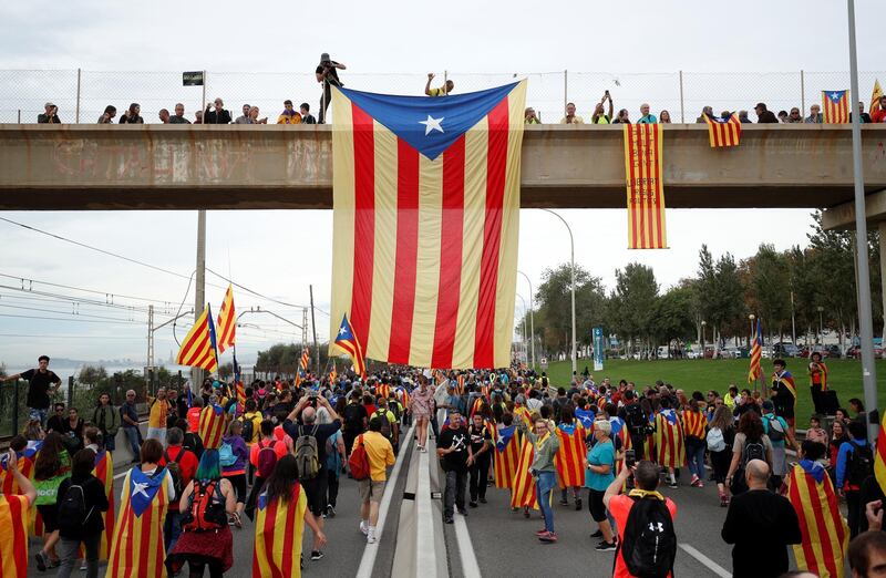 An Estelada (Catalan separatist flags) hangs from an overpass as demonstrators march during Catalonia's general strike in El Masnou, Spain, October 18, 2019. REUTERS/Albert Gea