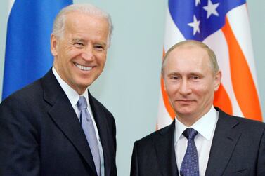 Then-vice president Joe Biden greets Vladimir Putin in Moscow in 2011. AP