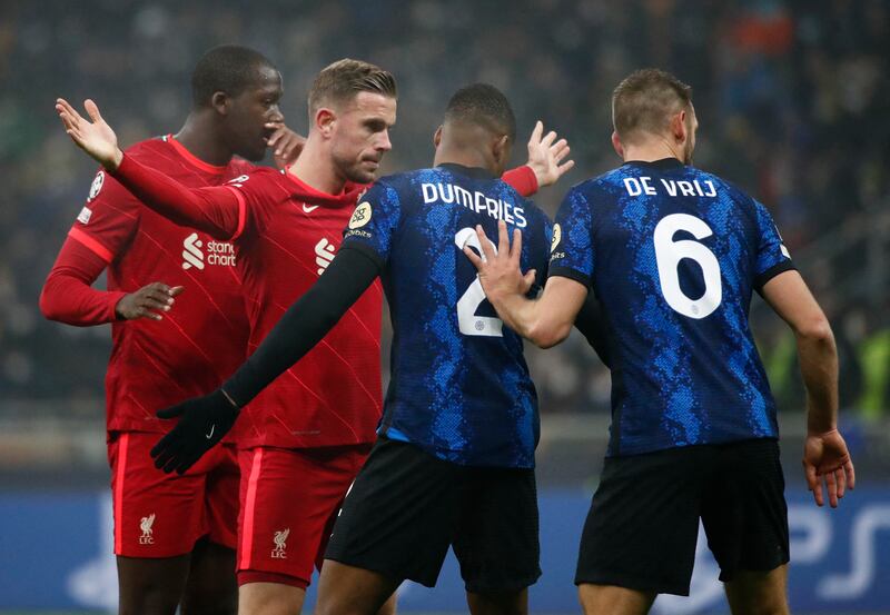 Liverpool's Jordan Henderson and Inter's Denzel Dumfries. Reuters